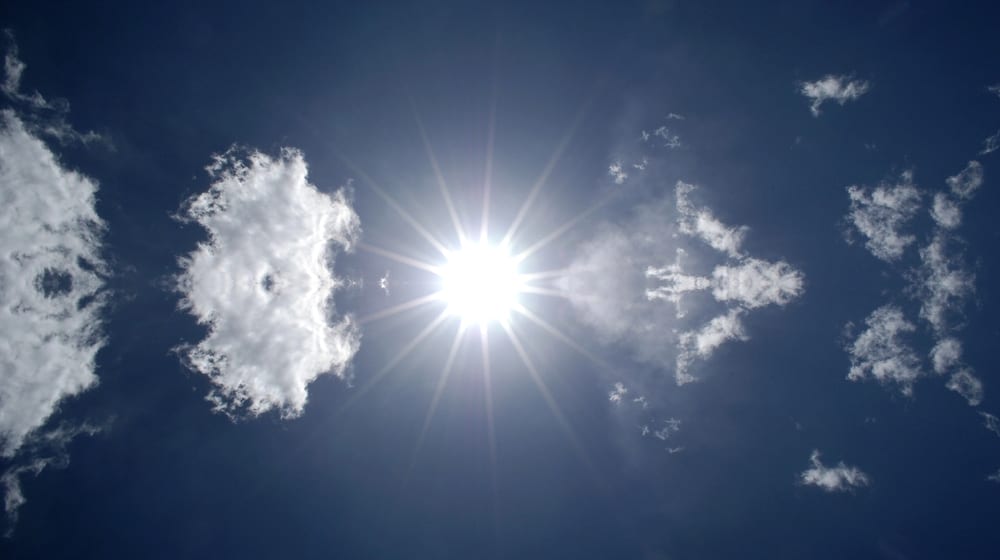 sun shining in a blue sky